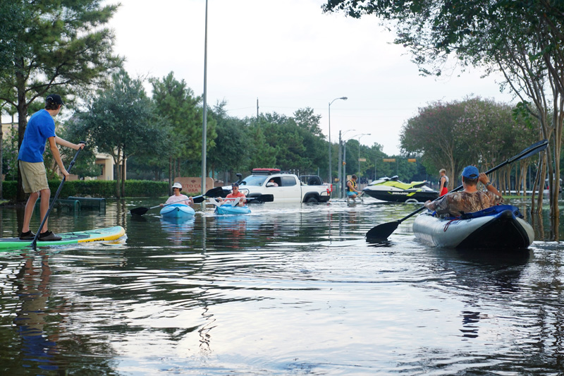 Residents use kayaks in Houston's flooded streets after Hurricane Harvey